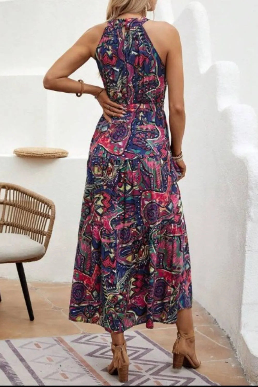 Back view of floral sleeveless dress showing tie detail and relaxed fit, ideal for summer wear