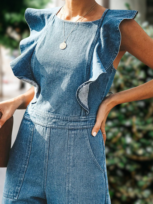 Model wearing a trendy backless denim jumpsuit with playful ruffles and sleeveless cut