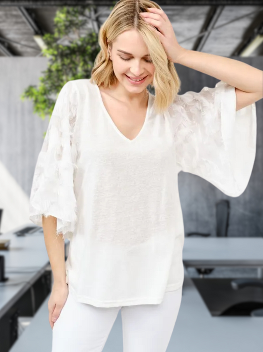 Woman wearing feather detailed 3/4 sleeve slub top in light slub fabric